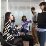 hr-employee-collects-cv-from-asian-lady-1.jpg