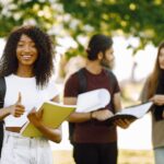 focus-african-girl-who-standing-sepately-shows-thumb-up-group-international-students-standing-togeth.jpeg