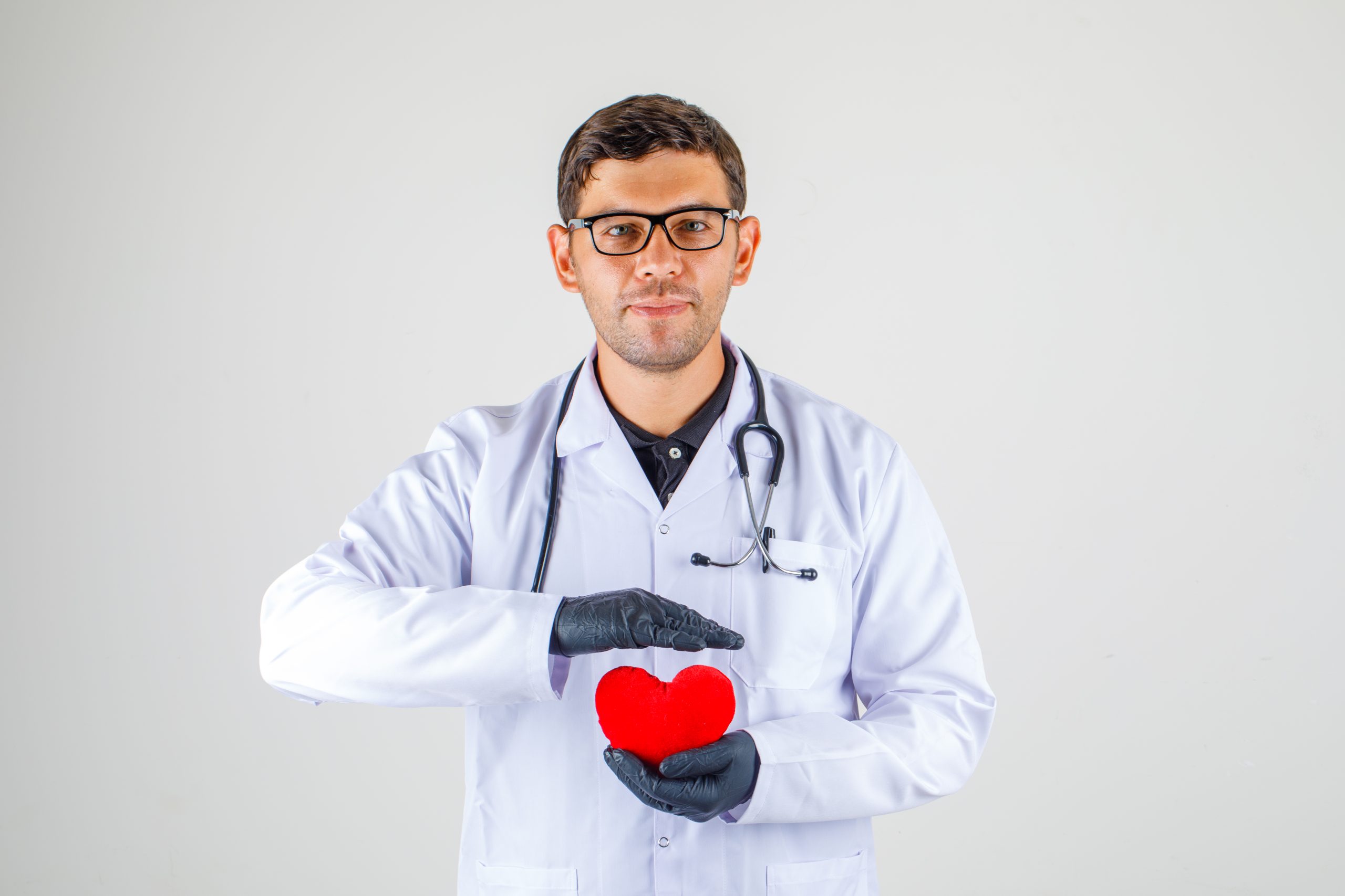 doctor-holding-heart-white-coat-with-stethoscope-looking-positive.jpg